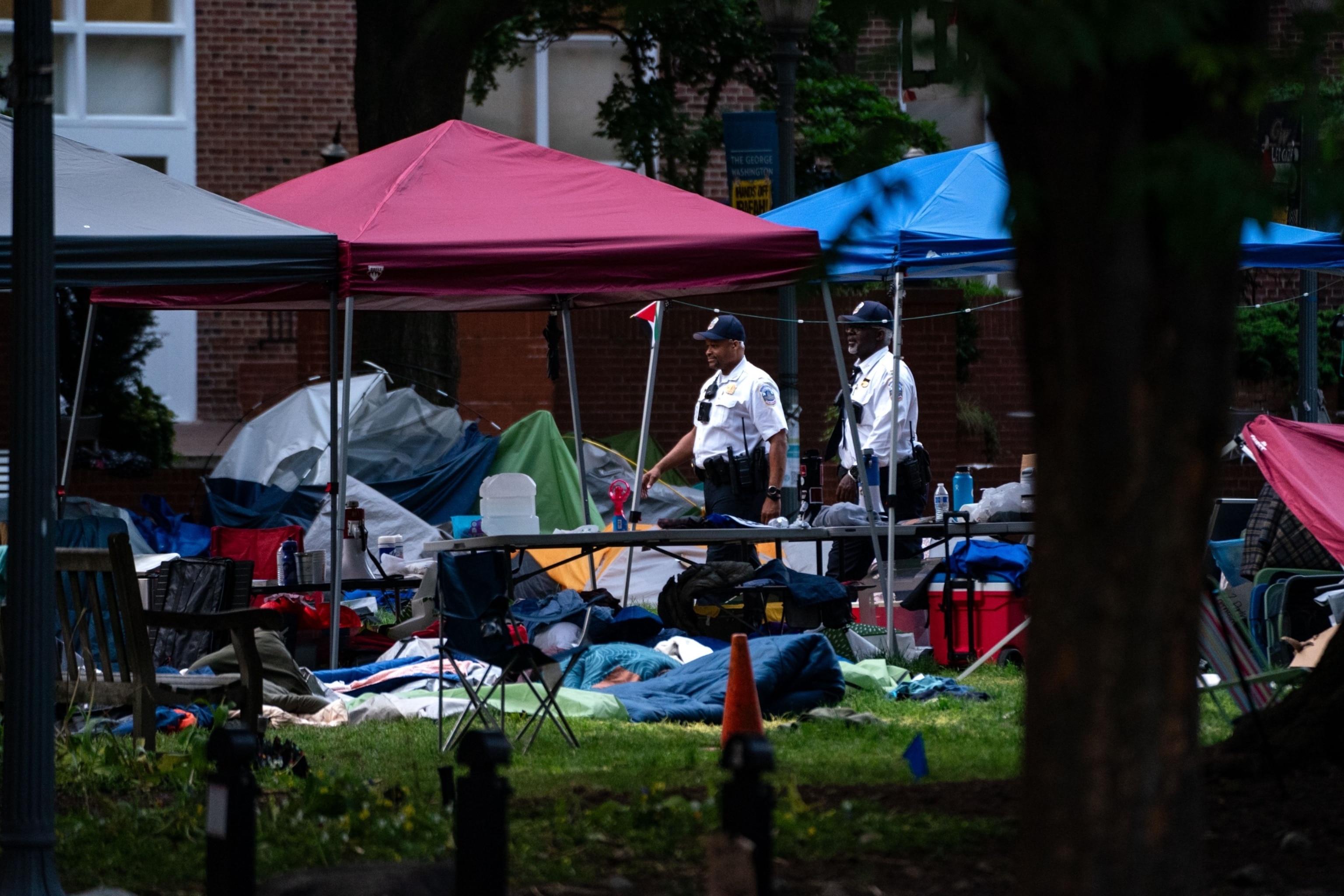 PHOTO: Law enforcement officers walk through a now empty Pro-Palestinian encampment at George Washington University's University Yard in Washington, DC, May 8, 2024.