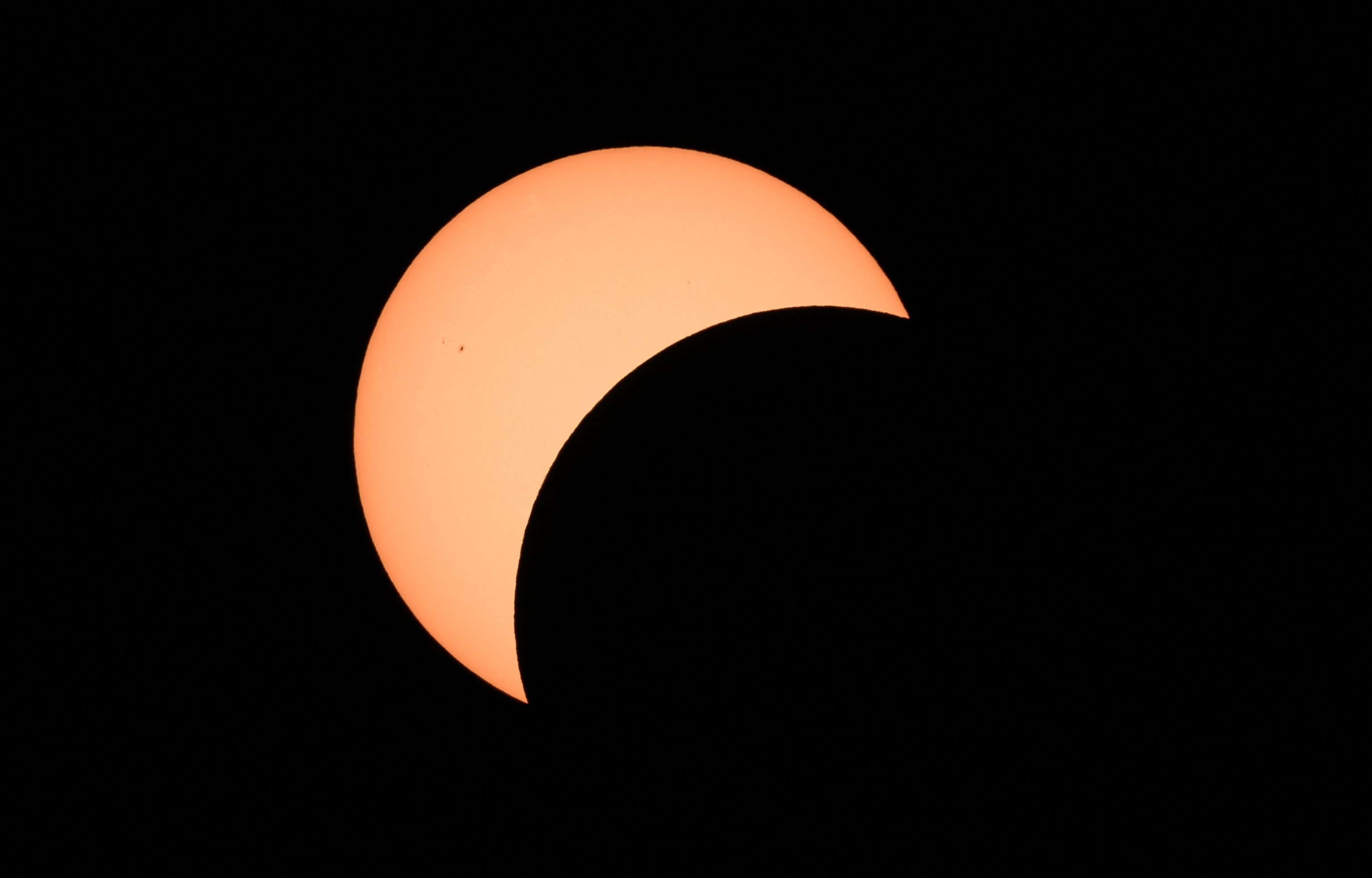 PHOTO: Early stages of a total solar eclipse shows the moon crossing in front of the sun in Bloomington, Ind., on April 8, 2024.