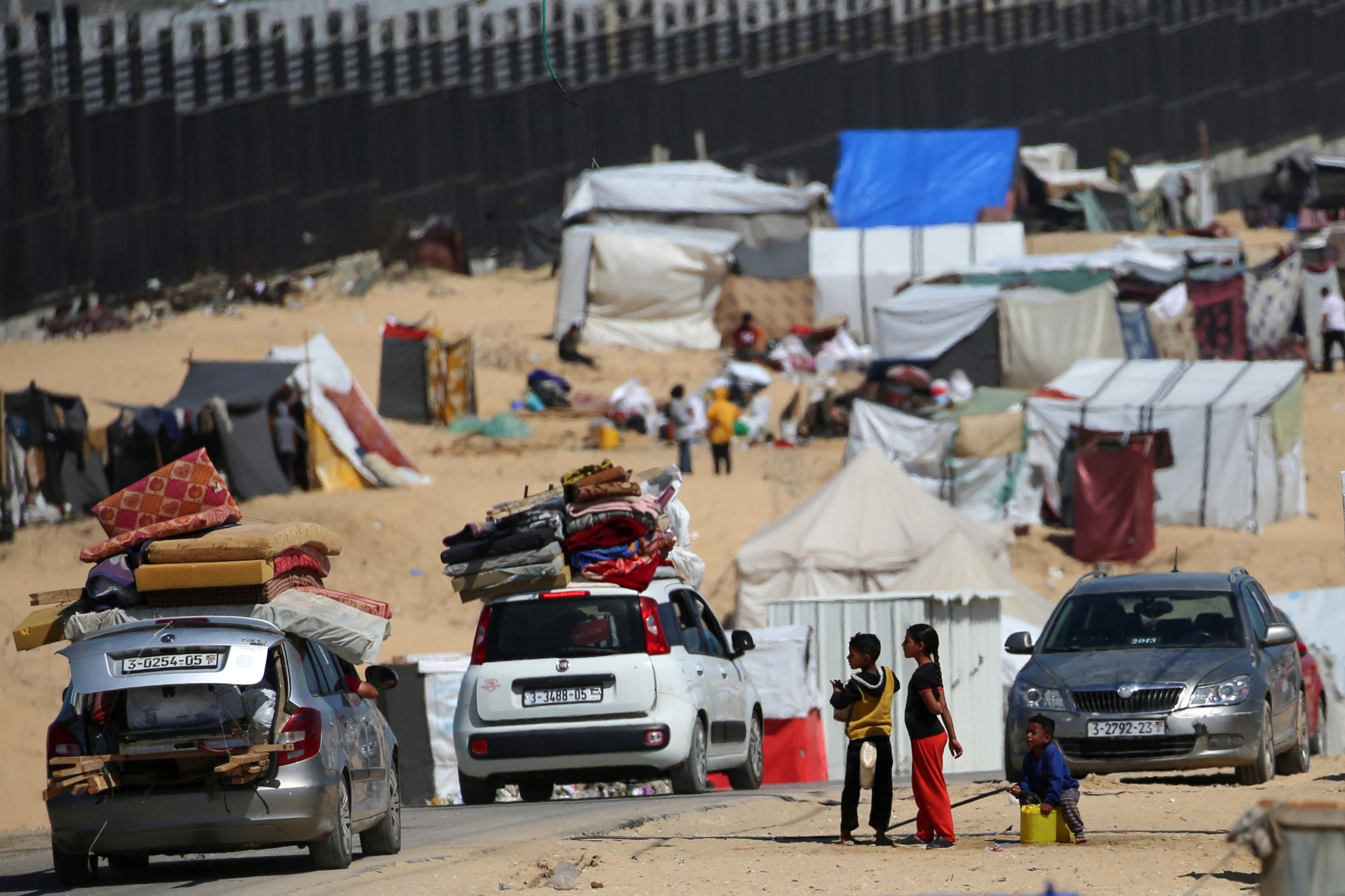 PHOTO: Displaced Palestinians transport their belongings on top of cars as they move to a safer area in Rafah in the southern Gaza Strip, May 9, 2024.