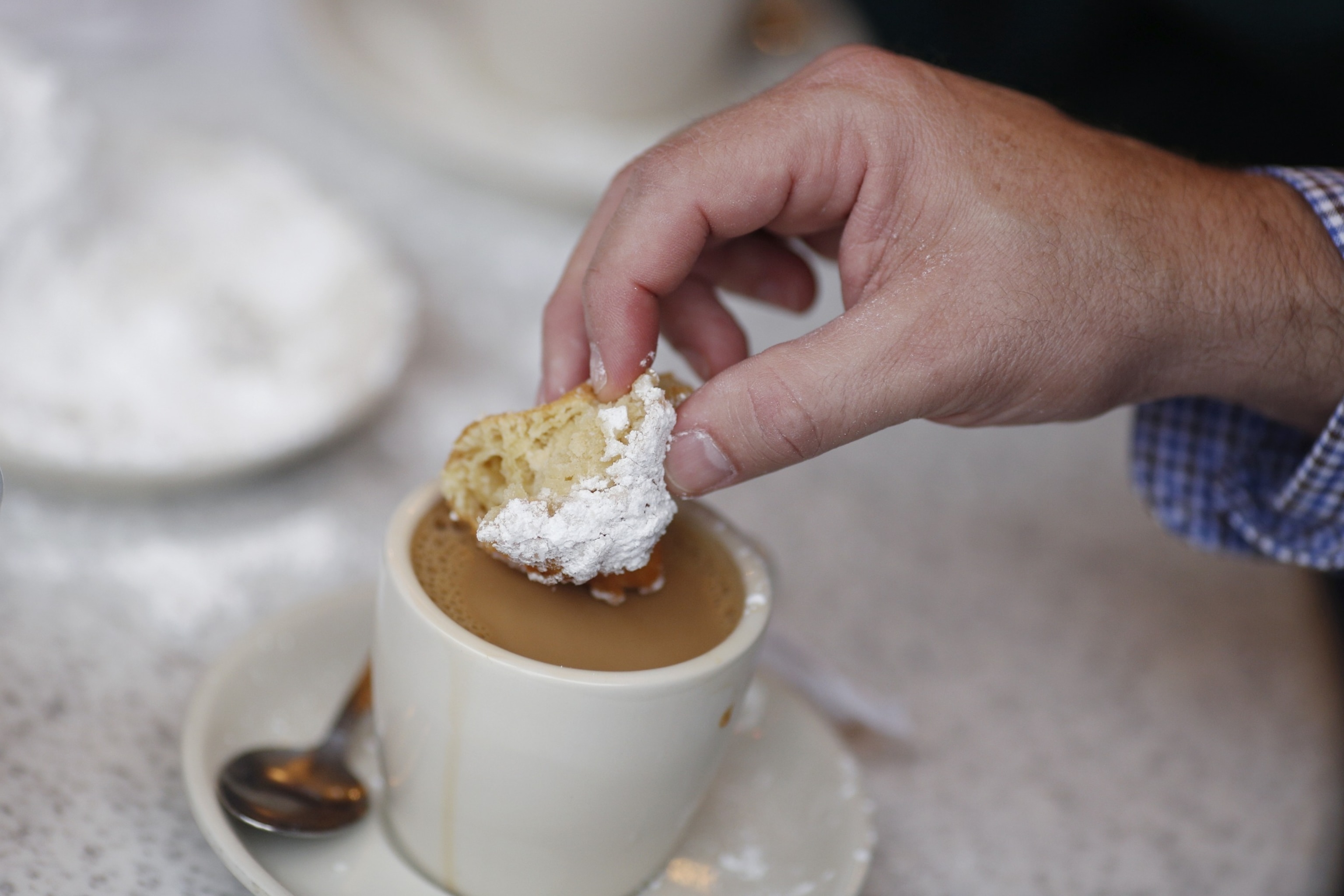 PHOTO: A customer eats a beignet at Cafe Du Monde in the French Quarter of New Orleans, Louisiana, U.S., Wednesday, Feb. 7, 2018.