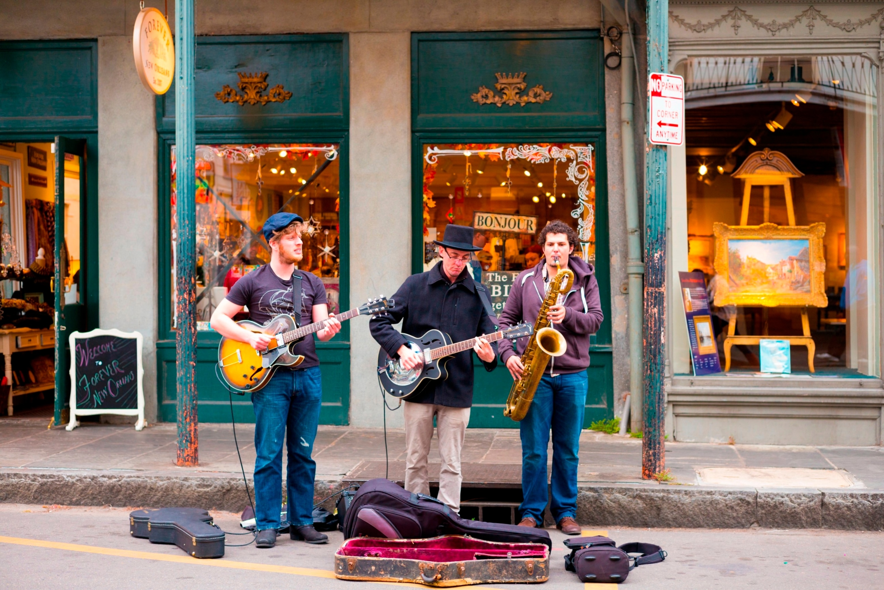 PHOTO: Jazz musicians saxophonist and guitarist in live busking performance on street corner in French Quarter, New Orleans, USA.