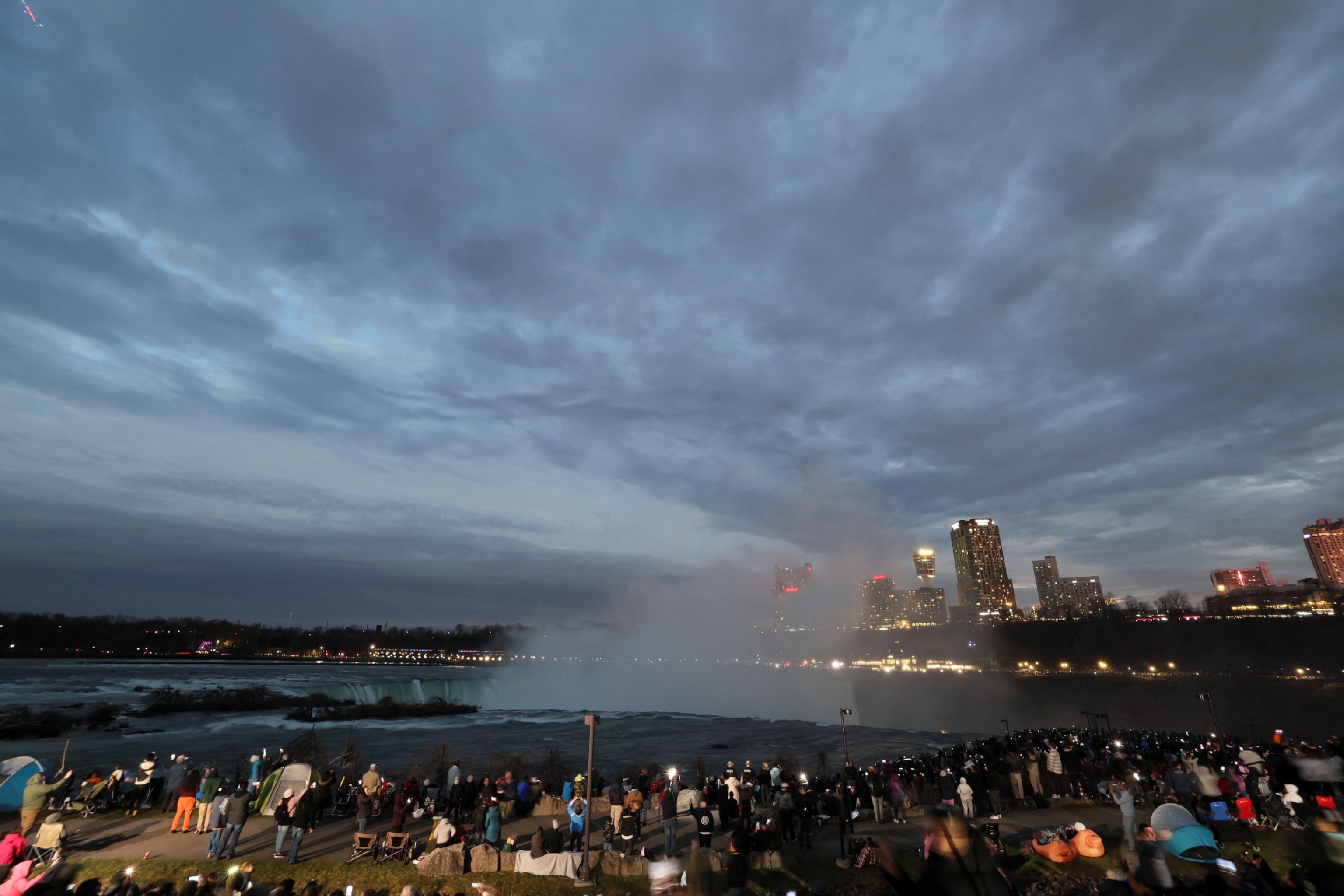 PHOTO: People assemble to view a total solar eclipse, where the moon will blot out the sun, at Niagara Falls, New York, April 8, 2024. 