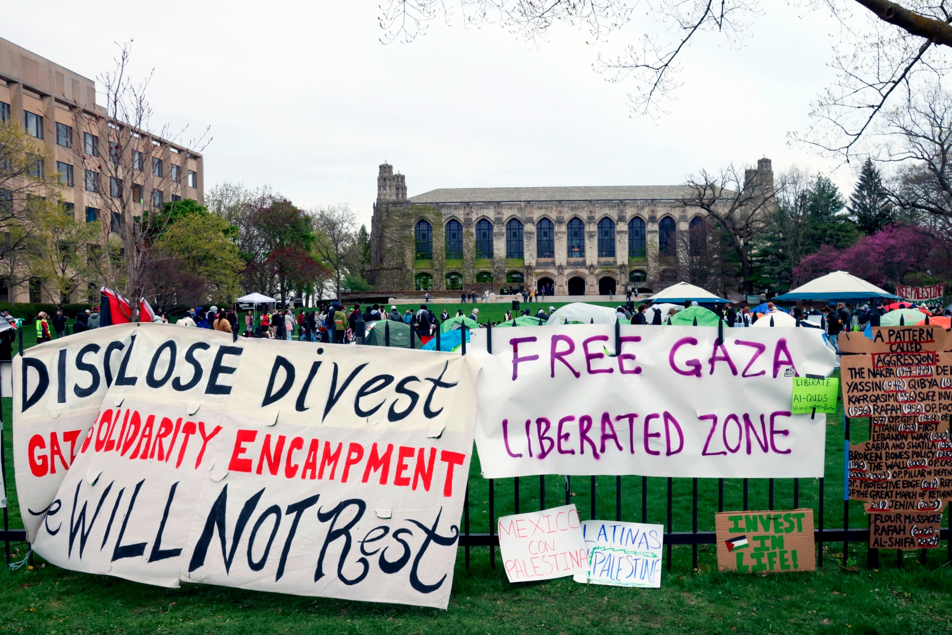 PHOTO: Signs are displayed outside a tent encampment at Northwestern University, April 26, 2024, in Evanston, Ill.