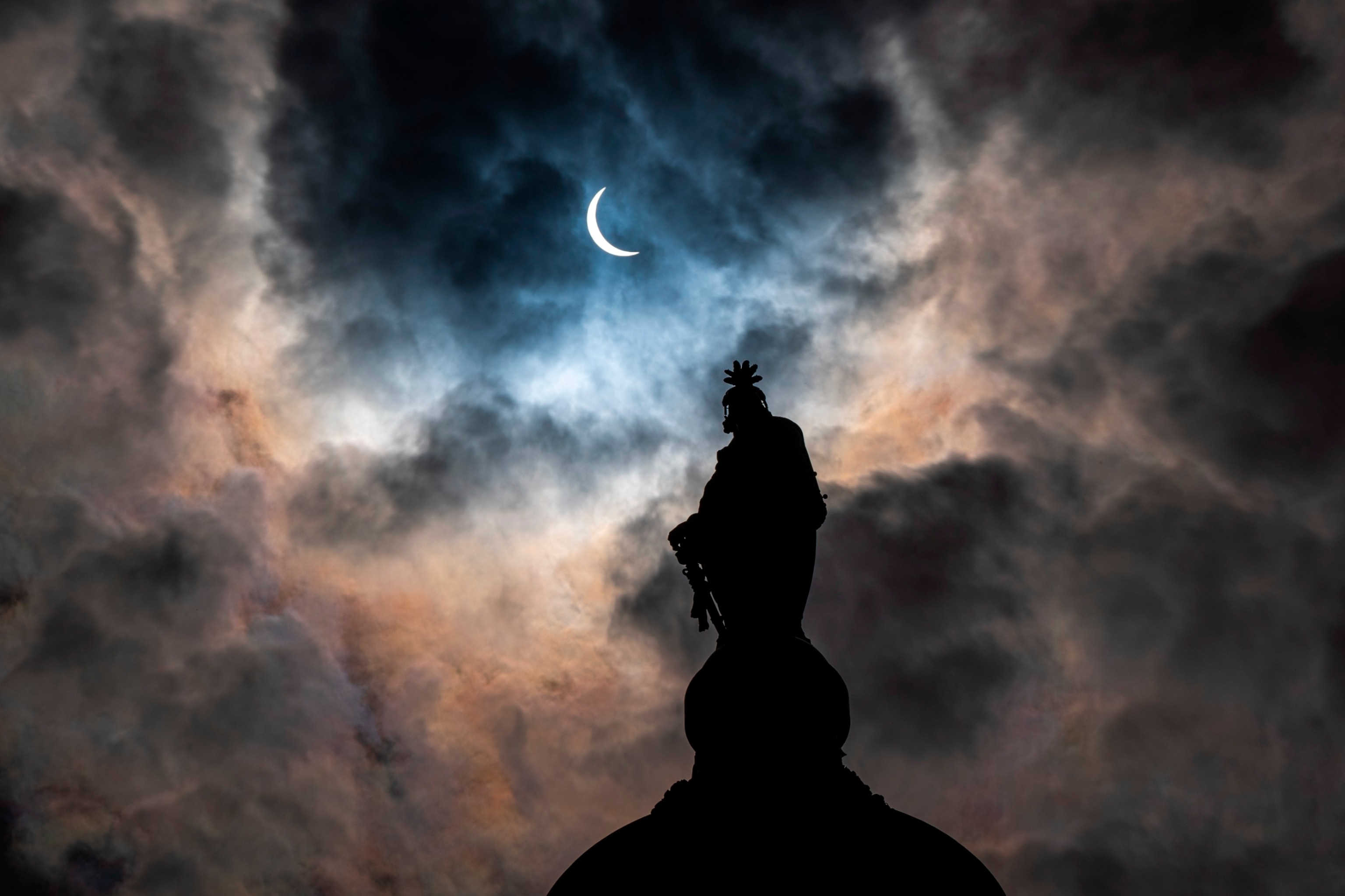 PHOTO: The Statue of Freedom on top of the U.S. Capitol stands as the moon partially covers the sun during a total solar eclipse, as seen from Capitol Hill, April 8, 2024, in Washington.